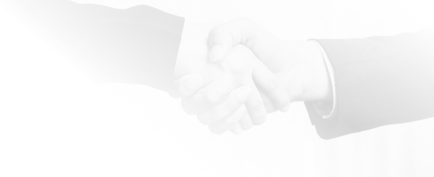 Two hands from people in business attire shaking hands.